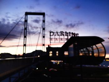 Silhouette of suspension bridge at dusk