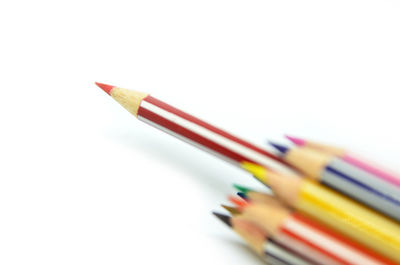 Close-up of colored pencils against white background