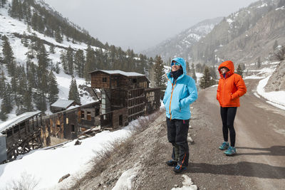 Women visit ute ulay mine ruins in winter near lake city, colorado