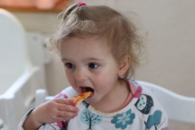 Portrait of cute girl eating food