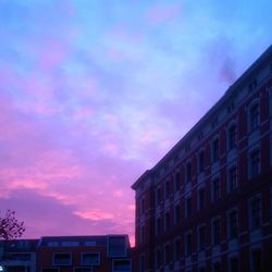 Low angle view of building against cloudy sky