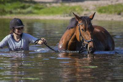 Woman with horse in river