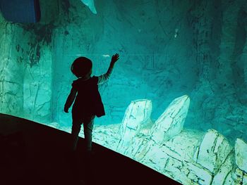 Boy standing in aquarium