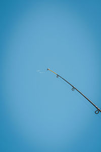 Low angle view of birds perching on street light