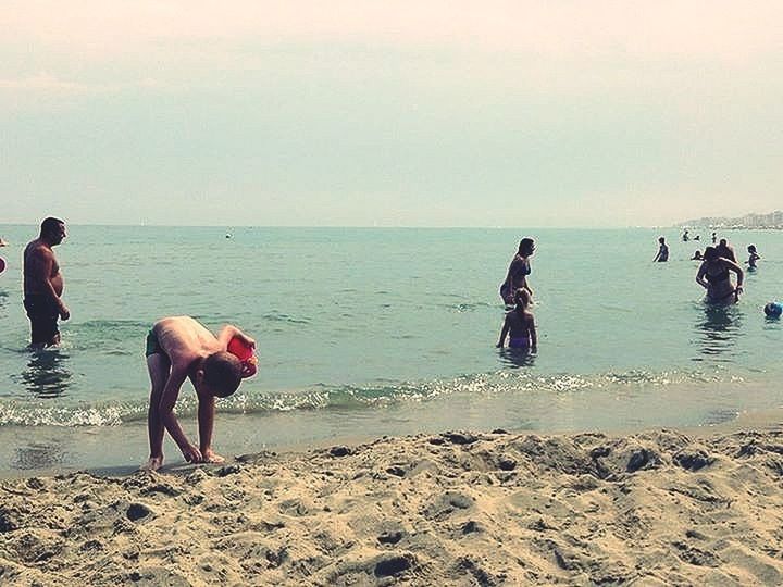 sea, water, beach, horizon over water, shore, lifestyles, leisure activity, full length, sky, men, sand, vacations, scenics, wave, standing, person, beauty in nature, enjoyment, nature