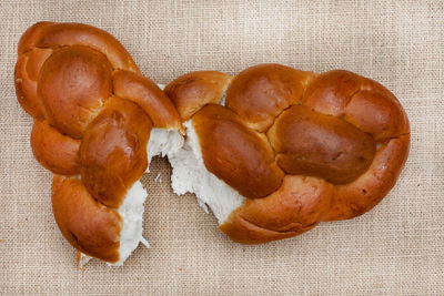 Challah or braided bread on rustic surface