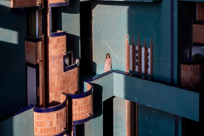 Rear view of man standing by building