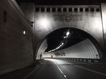 Illuminated tunnel at night