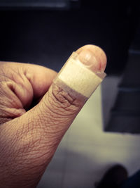 Close-up of hand holding cigarette