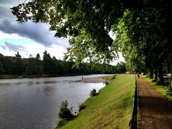 Scenic view of river against cloudy sky