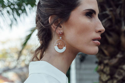 Close-up portrait of young woman looking away