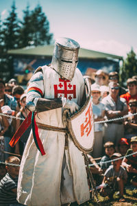 Group of people in traditional clothing against sky