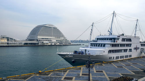 Ship moored at harbor against sky