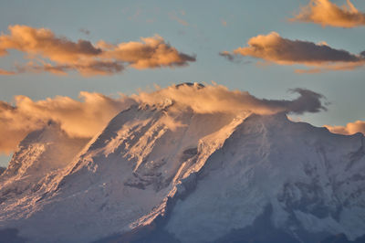 Scenic view of snowcapped mountains against sky during sunset