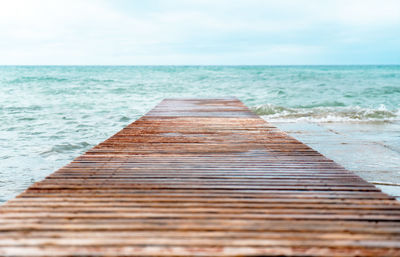 Surface level of empty beach against sky