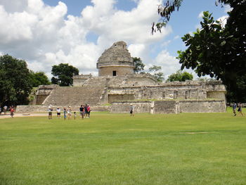 Tourists on grassy landscape