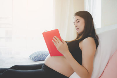 Beautiful woman sitting on red chair