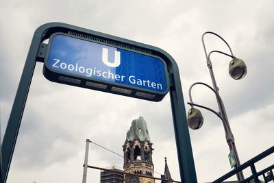 Low angle view of road sign against sky