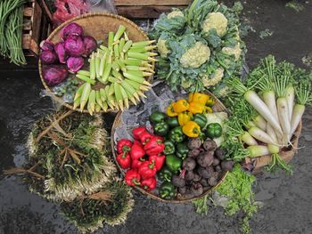 High angle view of vegetables in baskets at market stall