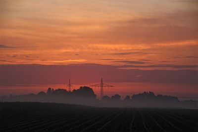 Scenic view of field against romantic sky at sunset