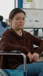 Portrait of young man sitting on chair