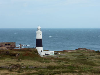 The mannez lighthouse  at quenard point on the northeastern side of the island of alderney,
