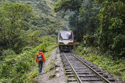 Hiker on train tracks that lead up to aguas calientes