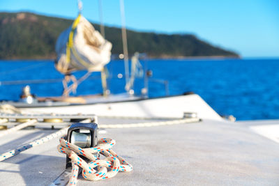 Close-up of sailboat moored on sea against sky