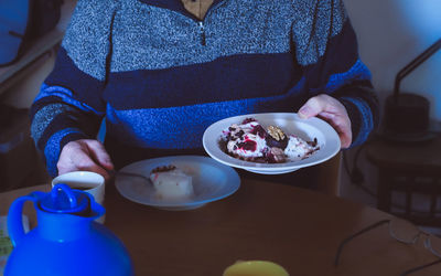 Midsection of woman having breakfast