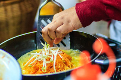 Close-up of man preparing food in kitchen