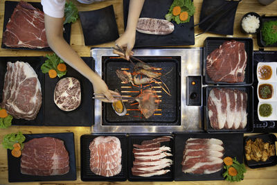 Directly above shot of cropped hands preparing seafood