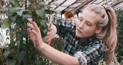 Portrait of woman holding plant