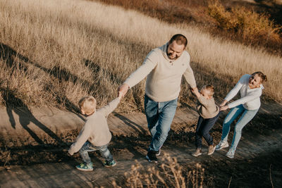 Full length of father and daughter on footpath