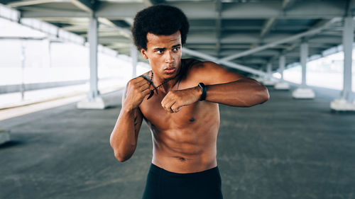 Young man looking away while exercising