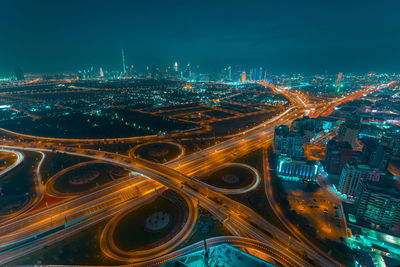 High angle view of illuminated city street and buildings at night