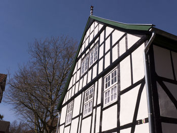 Low angle view of modern building against clear blue sky