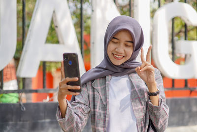 Beautiful muslim female student selfie in the park