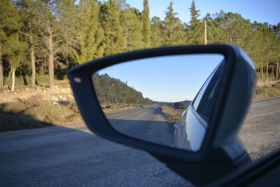 View of side-view mirror of car