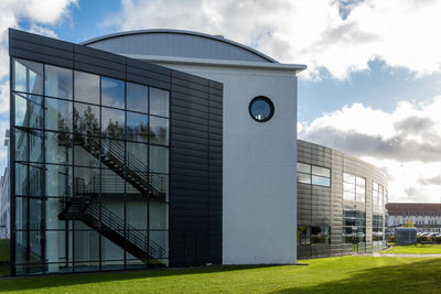 Street level view of a multi-storey building with modern european architectural designs.