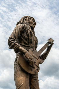 Low angle view of statue against sky