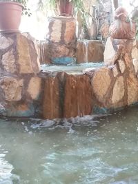 Water flowing through rocks in swimming pool