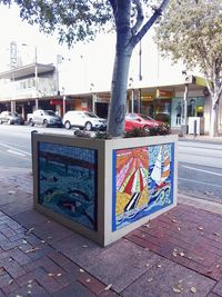 Text on footpath by street in city