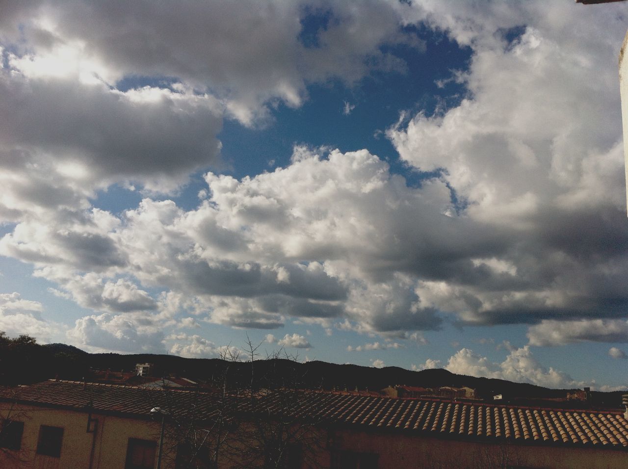 building exterior, architecture, sky, built structure, cloud - sky, cloudy, house, roof, cloud, residential structure, low angle view, residential building, weather, high section, overcast, outdoors, nature, town, no people, day