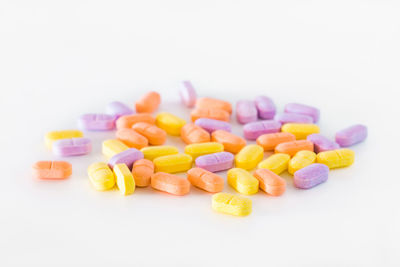 Close-up of multi colored candies against white background