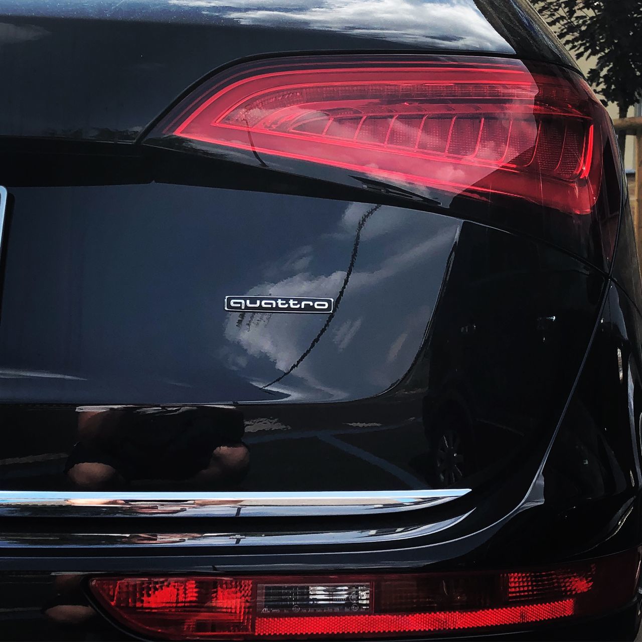 CLOSE-UP OF REFLECTION OF CAR ON GLASS