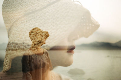 Double exposure of woman at lakeshore