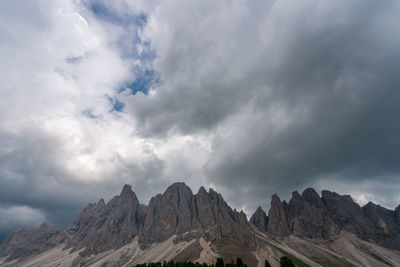 Low angle view of clouds over mountain range against sky