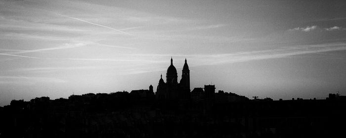 Buildings against sky at sunset