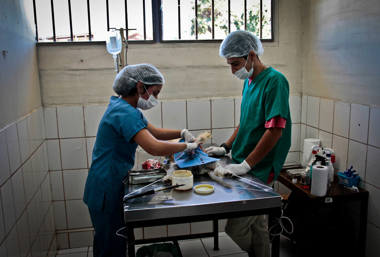 skill, two people, indoors, eyeglasses, working, workshop, adults only, real people, manufacturing occupation, people, teamwork, adult, only men, headwear, day