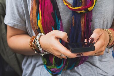 Midsection of woman holding smart phone